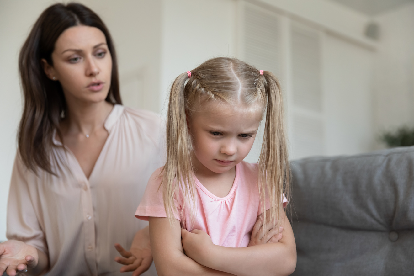 Angry mom scolding stubborn fussy upset little kid daughter